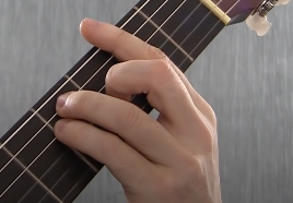 Guitar player learning the easy way to play the 6th string major Bar chord